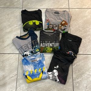 Bundle of 7 t shirts with various graphic designs.